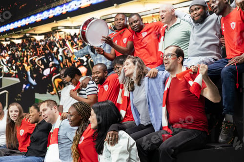 Preview: Packed stadium crowd of diverse soccer fans cheering with red scarves