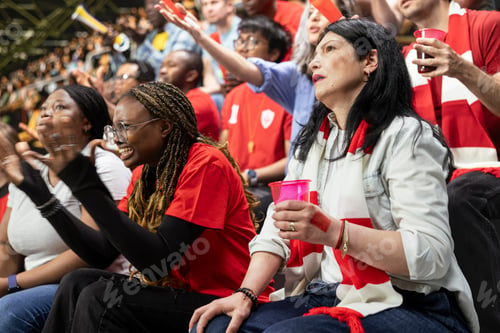 Preview: Female football supporters reacting with open hands and anxious faces