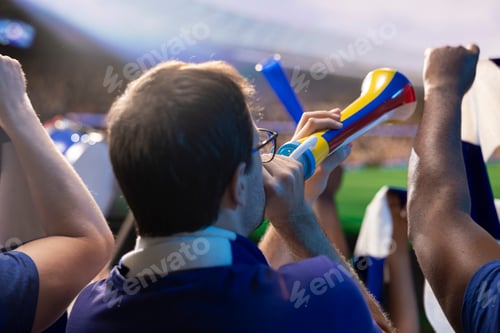 Preview: Close up of football supporters sounding vuvuzela from stadium seats