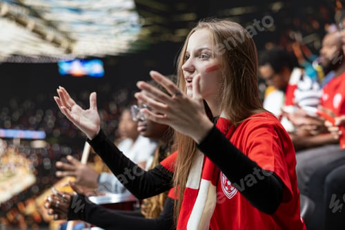 Preview: Young female football supporter gesturing with open hands in disbelief
