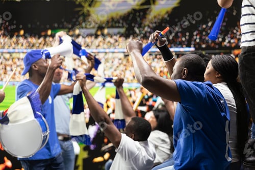 Preview: Dynamic football crowd leader motivating blue supporters with megaphone