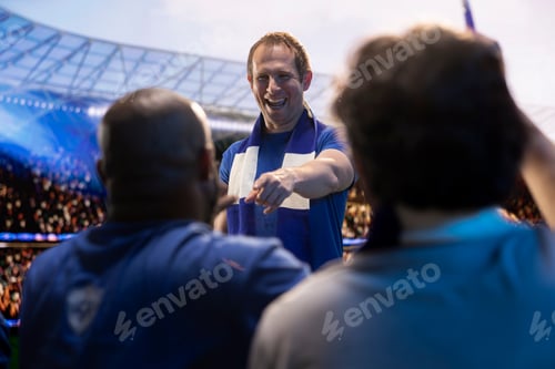 Preview: Cheerful soccer supporters celebrating together after winning match
