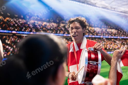 Preview: Excited football supporter beats drum among cheering fans in packed stadium