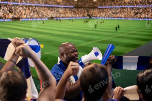 Preview: Passionate man on soccer stadium yelling in megaphone, cheering players