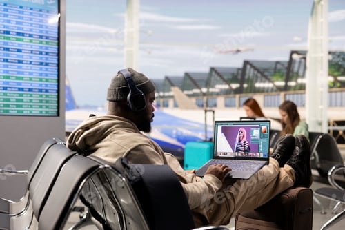 Preview: Digital nomad photo editor working on laptop in airport lounge