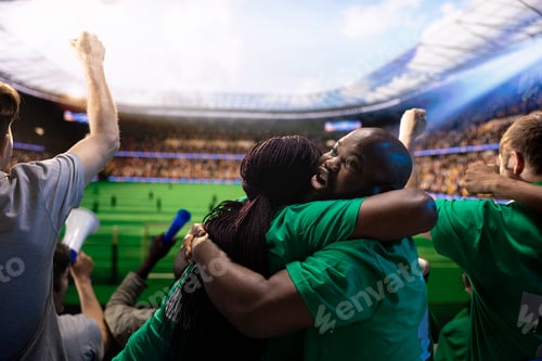 Preview: Happy football supporters hugging in stadium stands during emotional match