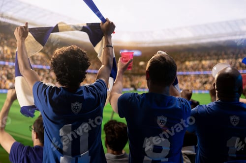 Preview: Football supporters in crowded stadium raising scarves during match day