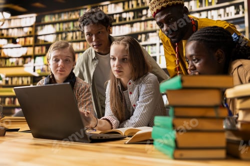 Preview: Diverse students working on laptop together at group study session