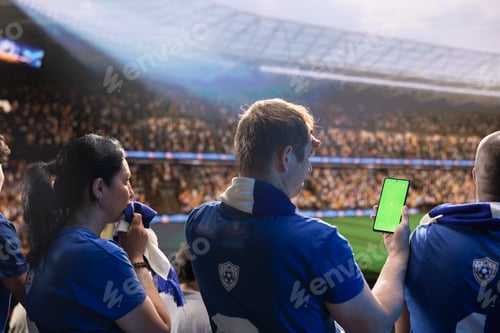 Preview: Isolated screen smartphone used by unhappy football supporter in stadium