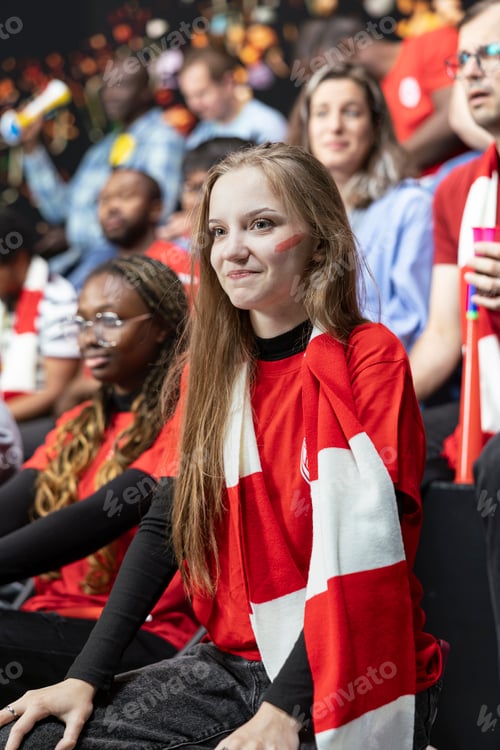 Preview: Portrait of young woman football fan with red scarf and face paint