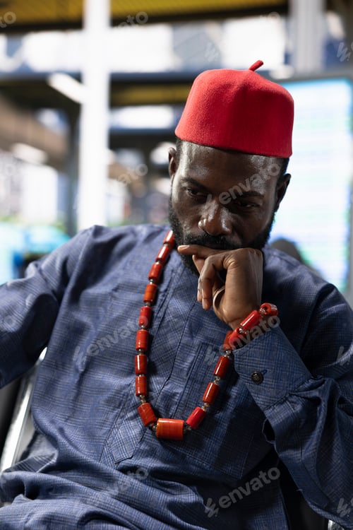 Preview: Tired traveler in african traditional clothes with beaded jewelry