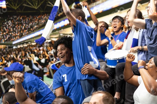 Preview: Black family celebrating with young child during exciting soccer match