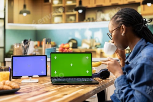 Preview: Green screen laptop and blue screen tablet with african american girl working