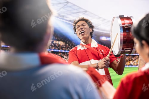 Preview: Passionate man on soccer stadium beating drum to rally football supporters