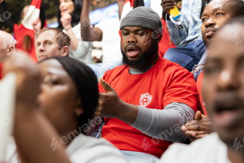 Preview: Black sports fan placing football betting wager through mobile sportsbook