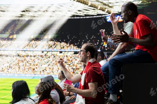 Preview: Wide stadium view of red team football supporters reacting during live match
