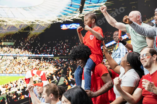 Preview: Proud dad celebrates with young fan son at football stadium for soccer match