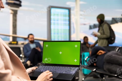 Preview: Green screen laptop near businesswoman in airport lounge during work trip