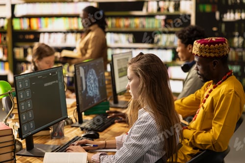 Preview: Students work at desktop with AI learning screens and digital study tools