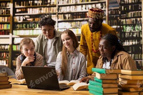 Preview: Diverse classmates in group study gather around laptop with study materials
