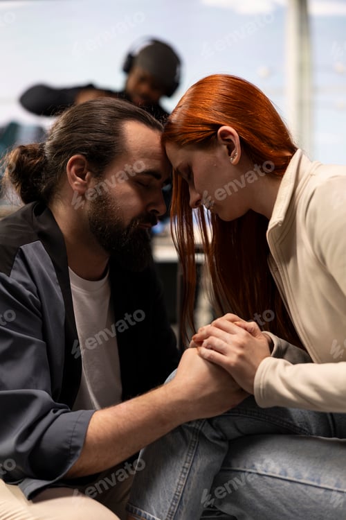 Preview: Young lovers cuddling in airport showing affection in intimate moment