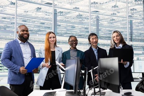 Preview: Cheerful engineering team in office monitoring microchip production quality