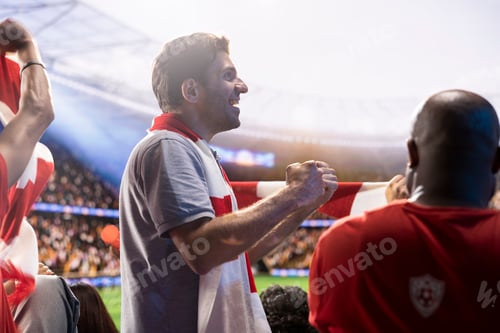 Preview: Happy man cheering in soccer stadium, celebrating goal scored and having fun