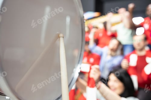 Preview: Close detail of fan drum and drumstick in stadium stands