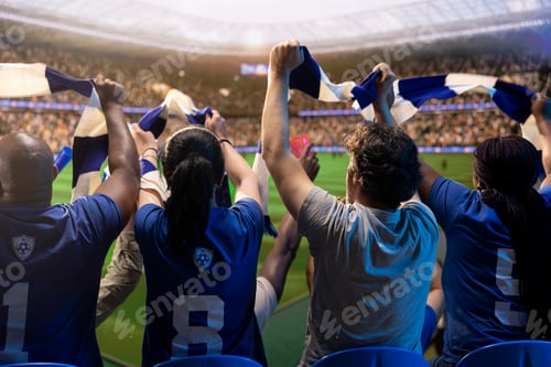 Preview: Rear view of football supporters raising scarves in packed stands