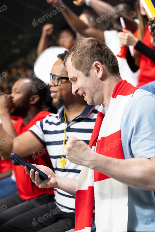 Preview: Diverse football fans cheering after winning live betting wager