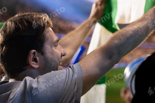 Preview: Close up of pleased soccer supporter watching game from stadium stands