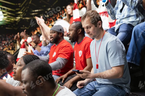 Preview: Football fan using smartphone to monitor in-play betting odds and predictions