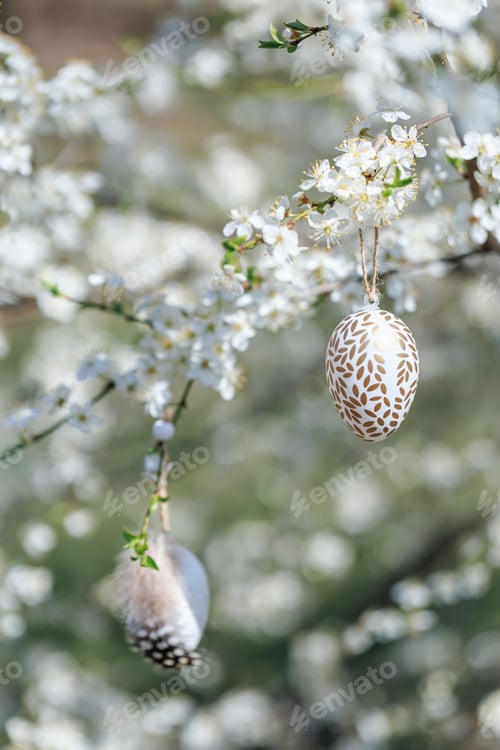 Preview: Easter eggs hanging on blooming spring tree