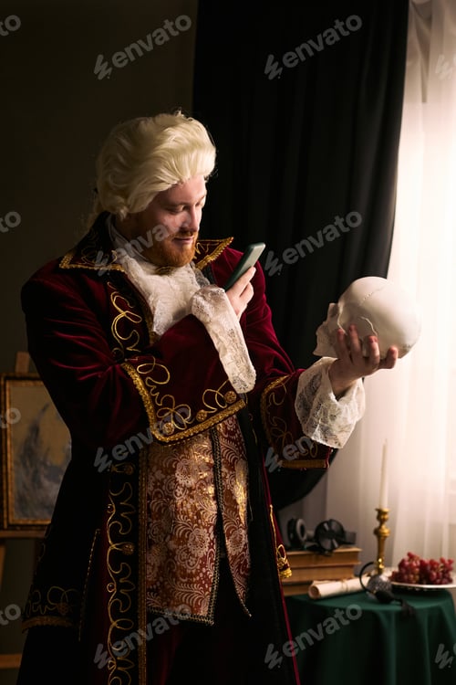 Preview: Man in Period Costume Using Smartphone While Holding Skull