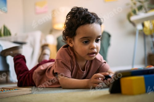 Preview: Black Toddler Playing on Floor at Home for Early Learning