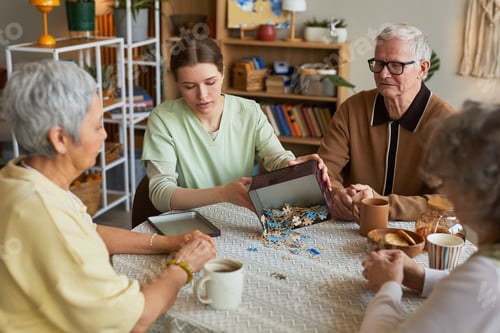 Preview: Senior Residents Solving Jigsaw Puzzle with Caregiver in Nursing Home
