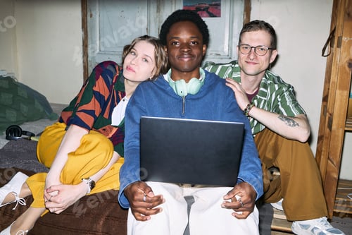 Preview: Portrait of Diverse Adult Friends Using Laptop for Shared Content