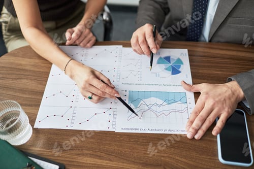 Preview: Business Colleagues Reviewing Financial Charts for Strategy Planning
