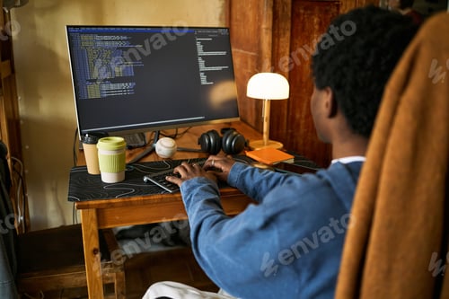 Preview: Black Man Coding at Home Office for Remote Software Development