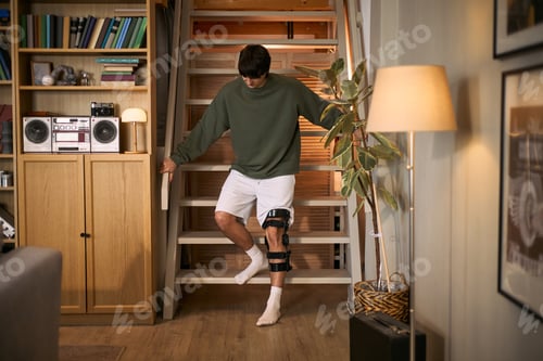 Preview: Adult Man with Disability Descending Stairs during Home Recovery