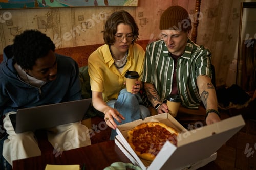 Preview: Diverse Adult Friends Sharing Pizza during Casual Team Meeting