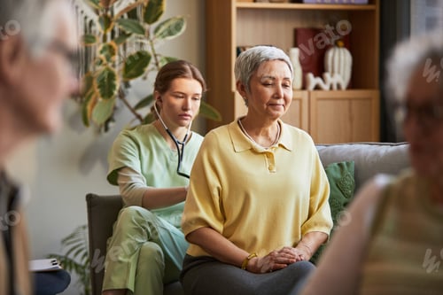 Preview: Senior Woman Receiving Checkup in Nursing Home Care Setting