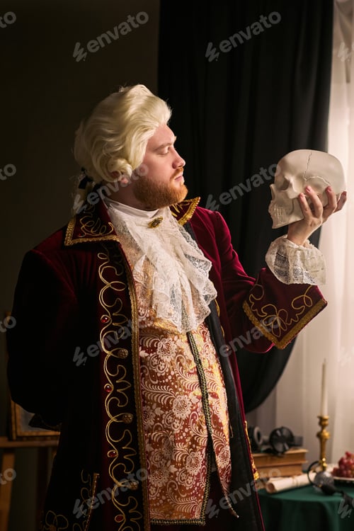 Preview: Man in Historical Costume Holding Skull for Theater Concept