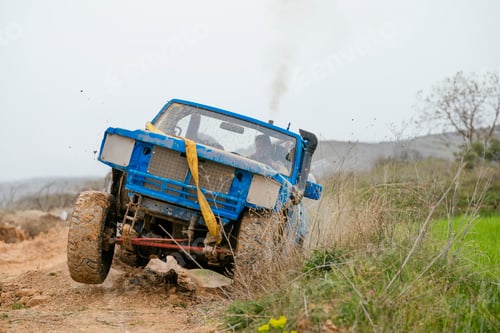 Preview: Blue off-road truck driving through dirt and mud