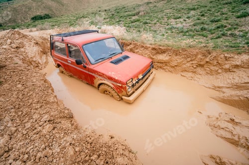 Preview: Red 4x4 vehicle stuck deep in mud