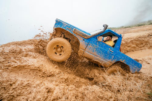 Preview: Blue off-road truck splashing mud during extreme adventure