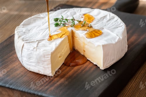 Preview: Golden Maple Syrup Pouring Over Camembert Cheese On Rustic Wooden Board Elegantly