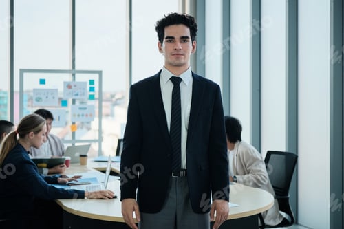 Preview: Confident male Hispanic CEO standing and looking at camera in meeting.