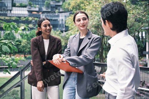 Preview: Three businesspeople are discussing jobs at outdoor communication workplace.