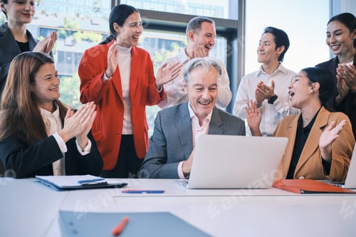 Preview: Business multiracial team is cheerful with stock trading incomes on a laptop.